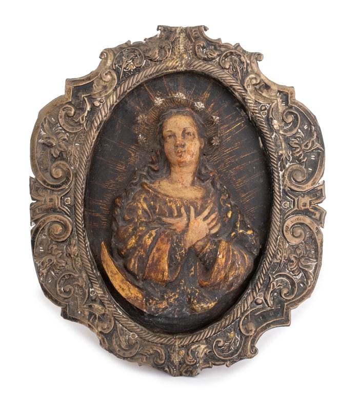 South American Madonna Carved Relief Sculpture: South American Carved Wood Madonna Relief Sculpture, 17th century, the Madonna with silver halo and gilding to robes, encased in silver frame with scroll form decoration. 11" H x 9.25" W. Provenance: 