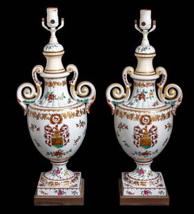 Chinese Export Style Armorial Porcelain Lamps, Pr: Pair of Chinese Export Style Armorial Porcelain Two Handled Vases Mounted as Table Lamps, 20th century, each decorated with polychrome flowers and a central coat of arms, depicting a knight's helmet a