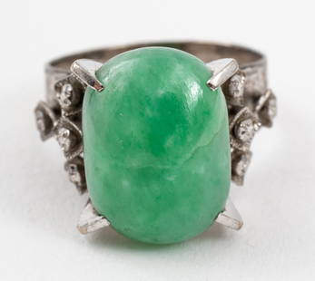 Mid-Century Modern 10K White Gold Oval Jade Ring: Mid-Century Modern 10K White Gold Oval Jade Ring, prong-set with one oval cabochon-cut jade; approx: 14.6 x 10.6 mm. Marked: "10K" with Korean characters. Ring measures: 1.18"L x 0.62"W at widest sect