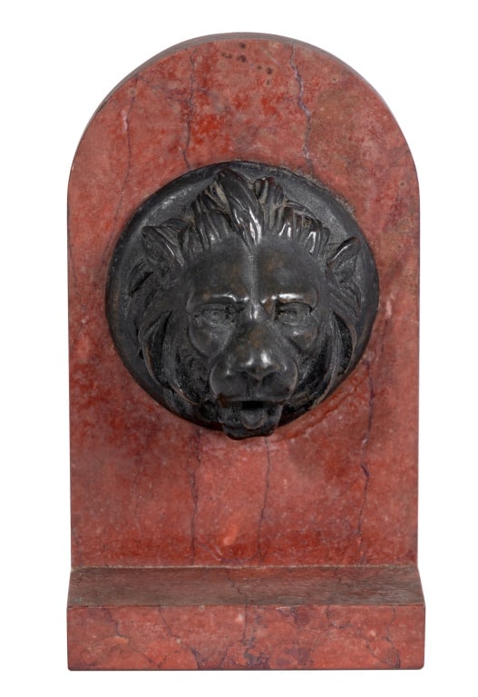 French Patinated Bronze and Marble Lion Mask: French Patinated Bronze and Rouge Marble Lion Mask, late 19th century, the mask mounted on an arched marble tablet and base. 5.5" H x 3.25" W x 2" D. Keywords: French sculpture, Neoclassical, Bronzier