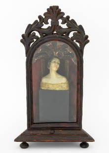 Victorian Carved Wax Female Bust: Victorian Carved Wax Female Bust, mounted in carved wood and glass arched display case with pierced foliate finial, fabric covered interior, on four bun feet. 15.5" H x 8.75" W x 4.75" D. Provenance: