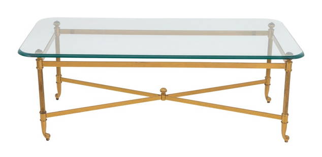 Modern Glass Top Brass Coffee Table: Modern Glass Top Brass Coffee Table, with four column form legs on scroll feet conjoined by X-form stretcher. 16" H x 43" W x 20" D. Provenance: From a New York City Collection. Keywords: Vintage Furn