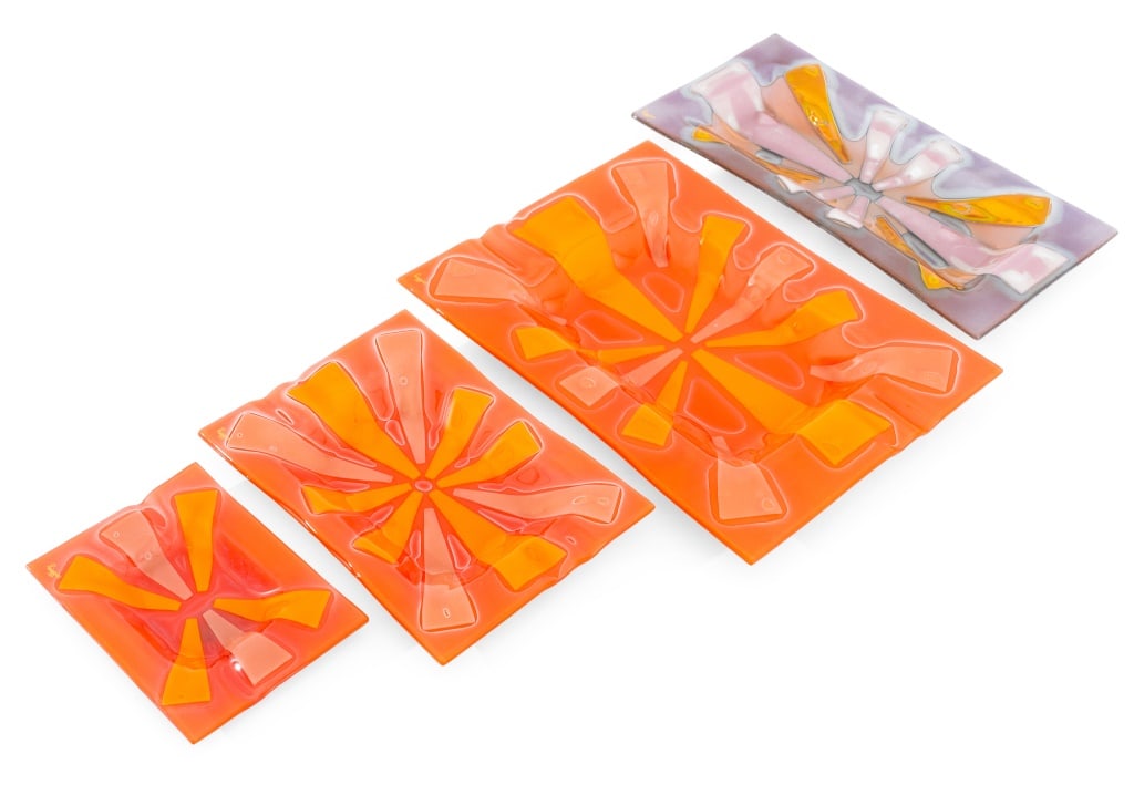 Frances & Michael Higgins Art Glass Trays, 4: Frances and Michael Higgins (American, 1912-2004; 1908-1999) Four Art Glass Trays, comprising: set of three graduated serving trays in orange and single rectangular tray in purple and gold-tone, all s