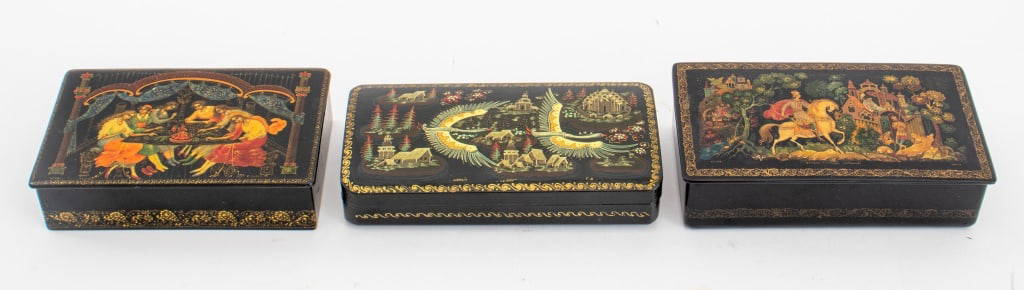 Russian Lacquer Boxes, 2: Three Russian Lacquer Boxes, all rectangular, the first inscribed in Cyrillic "Kholui 'The Tale of the Sleeping Tsarevna' Sedov", the second inscribed in Cyrillic "Kholui 'SIberia' GD." and the last f