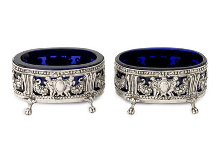 German Hanau Silver Oval Open Salts, Pair: Pair of German Hanau Silver Oval Open Salt Cellars, struck with marks for Storck & Sinsheimer, with pierced grapevine motif on four ball feet and cobalt blue glass inserts, marked to underside of