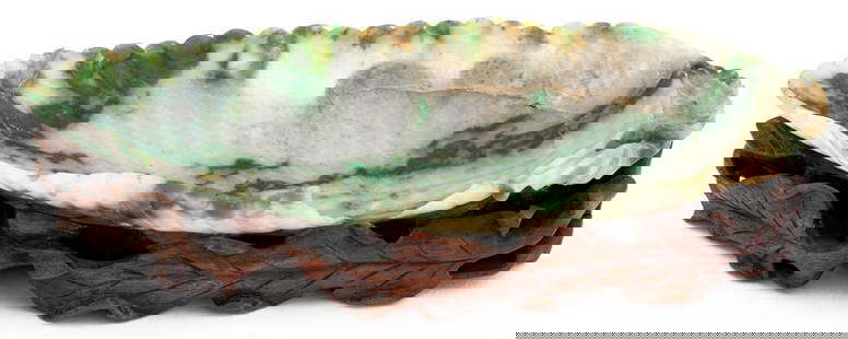 Chinese Carved Jadeite Leaf Form Brush Washer: Chinese Carved Moss in Snow Jadeite Leaf Form Brush Washer, on a reticulated carved wood stand. Overall: 1.25" H x 6.5" W x 3.25" W. Provenance: From an East 72nd Street Estate. Keywords: Asian Arts,