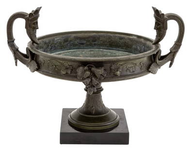 Grand Tour Verdigris Patinated Bronze Urn: Grand Tour Verdigris Patinated Bronze Urn, with two masque head handles and scrolling floral motif, atop a black marble plinth. 10.75" H x 14" W x 10.5" D. Provenance: From a Park Avenue Collection.