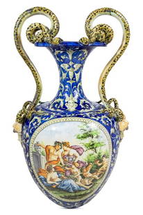 Italian Majolica Two Handled Urn Vase: Italian Majolica Two Handled Urn Vase, with entwined snake form handles with masque head terminals, decorated with bacchanalian scene and cherubs. 31" H x 20" W x 15" D. Keywords: Pottery, Ceramics,