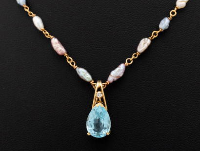 14K Gold Pearl Necklace & Topaz Diamond Enhancer: 14K Yellow Gold Cultured Freshwater Pearl Necklace and Blue Topaz Diamond Enhancer, featuring one prong set pear brilliant cut blue topaz weighing approx. 3.50 carats, further adorned with one prong