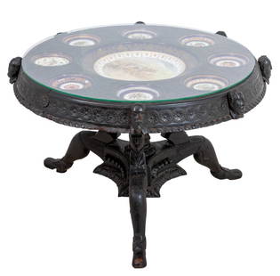 Victorian Porcelain Mounted Carved Oak Table: Victorian Porcelain Mounted Carved Oak Circular Coffee Table, in the Renaissance style, late 19th century, the top inset with various porcelain saucers, centered by a plate painted with cows, the oute