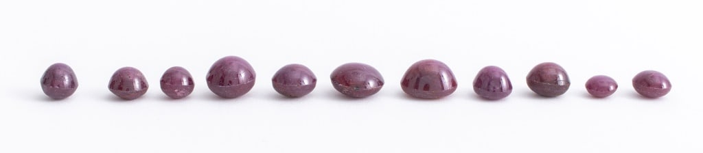 Loose Natural Indian Star Ruby Lot, 86.2 Cttw.: Loose Natural Indian Star Ruby Lot, 86.2 Carats Total Weight, comprised of eleven round and oval cabochon-cut star rubies of various sizes; from approx: 7 mm to 13 mm. Provenance: From a Bronxville, N