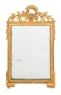 Louis XVI Giltwood Mirror: Louis XVI Giltwood Mirror, 18th century, with beveled glass mirror plate and laurel wreath cresting. Mirror plate: 31.5" H x 22.5" W; frame: 49.25" H x 29" W x 1.75" D. Provenance: Property from the r