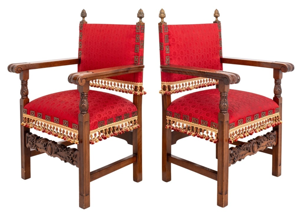 Renaissance Revival Mahogany Armchairs, Pair: Pair of Renaissance Revival Mahogany Arm Chairs, each with finial topped uprights framing an upholstered back issuing scrolling volute arms, above a square upholstered seat supported by four carved le