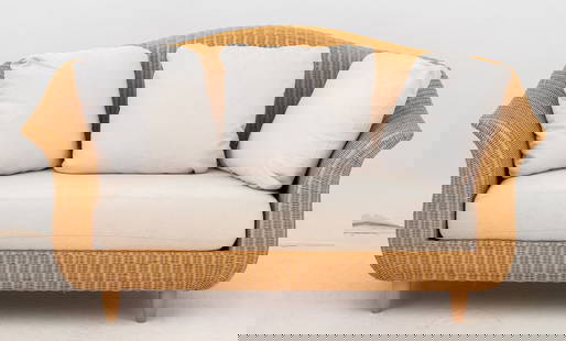 Varaschin Wicker Two-Seat Sofa: Varaschin Woven Wicker Two-Seat Sofa, with beige upholstered cushion, on four tapered legs. 34.5" H x 64.5" W x 30" D; seat: 17" H. Provenance: From a Vintage Collection of Italian Designer Furniture