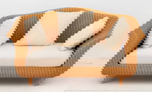 Varaschin Wicker Two-Seat Sofa: Varaschin Woven Wicker Two-Seat Sofa, with beige upholstered seat on four tapered legs. 34.5" H x 63" W x 30" D; seat: 16" H. Provenance: From a Vintage Collection of Italian Designer Furniture Sample