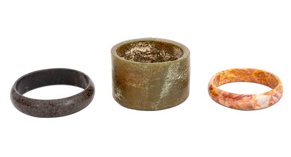 Carved Stone Bangles, 3: Collection of Three Carved Stone Bangles, including: pink agate, black agate, and nephrite. Largest bangle: 3.25" Diameter. Provenance: From the Upper East Side Apartment of a Former Ambassador. Keywo