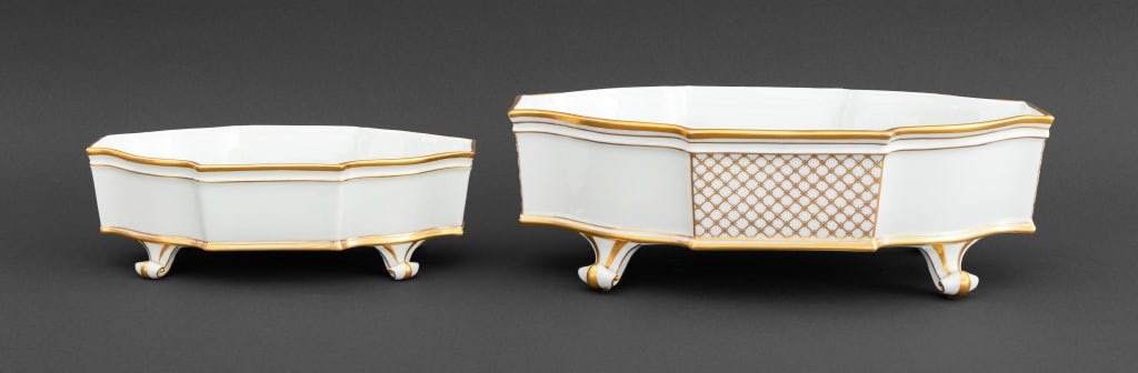 French Gilt Porcelain Graduated Jardinieres, 2: Two French Gilt and White Glazed Porcelain Graduated Jardinieres, each marked "Limoges / France" and atop four scrolled feet. Larger: 4.25" H x 12.75" W x 7.5" D. Provenance: From a Greenwich, Connect