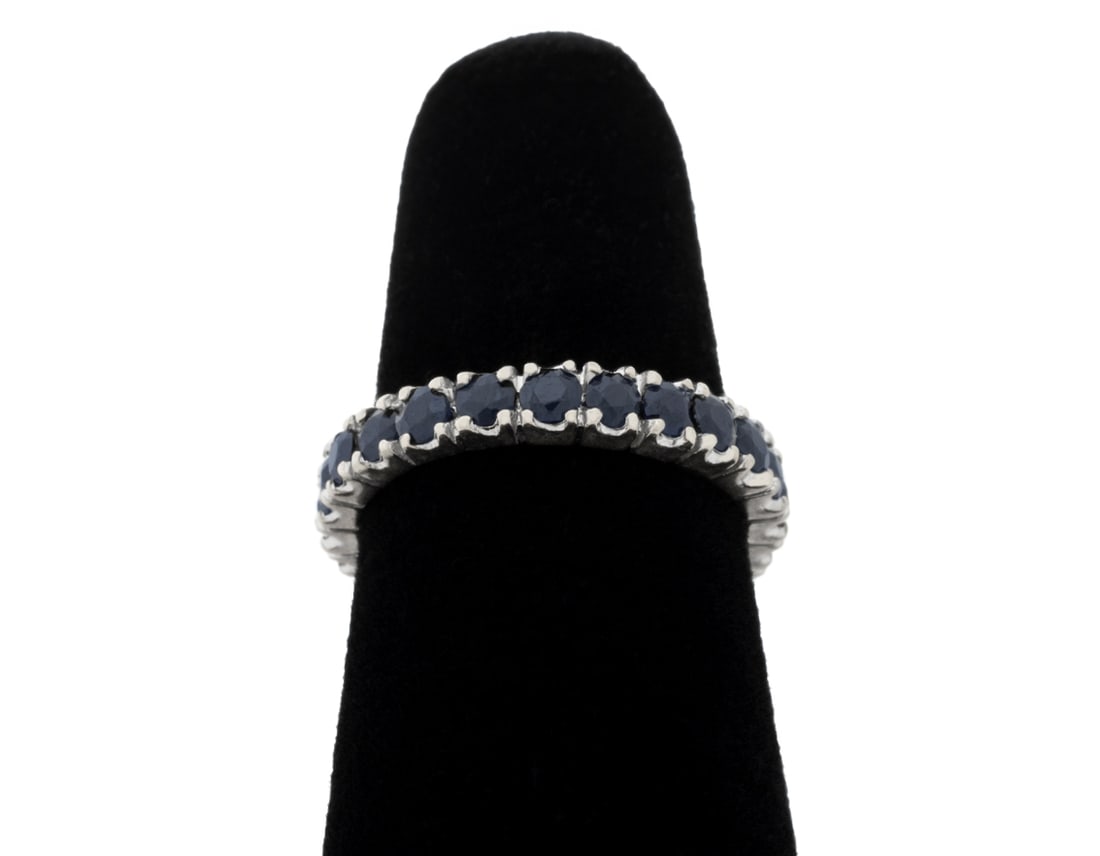 14K White Gold Blue Sapphire Band: 14K White Gold Blue Sapphire Band, featuring twenty four prong set round brilliant cut blue sapphires weighing a total of approx. 1.25 carats, Gold tested. Measuring approx. US size 5, 1.5 dwt.. Prove