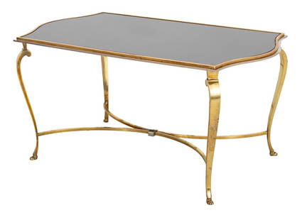 Hollywood Regency Glass Top Coffee Table: Hollywood Regency Brass and Smoked Glass Top Coffee Table, with chromed edge, X-form support, and paw feet. 18" H x 36" W x 20" D. Provenance: From a New York City Collection. Keywords: Vintage Furnit