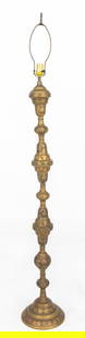 Moroccan Engraved Brass Floor Lamp: Moroccan Engraved Brass Floor Lamp, allover engraved with floral motifs, the sections turned and stacked above a circular base, similarly decorated with black and red enamel. 64" H x 10" Diameter. Pro