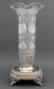 Victorian Cut Crystal and Silver Plate Vase: Victorian Cut Crystal and Silver Plate Vase, 19th century, with ruffled edge and floral etched motif mounted on silver plate base with four cherub head scroll feet, unmarked. 20" H x 9" W x 9" D. Prov