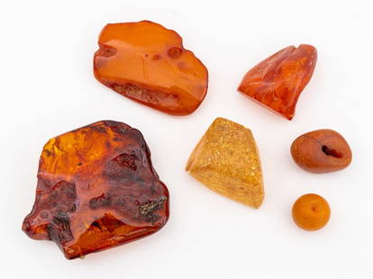 Amber Specimens and Beads, 6: Group of Six Amber Specimens and Beads, comprising: two (2) beads, one (1) mounted as pin, and three (3) natural amber pieces. Largest: 3" L x 2.75" W. Provenance: From a New York City Collection. Key