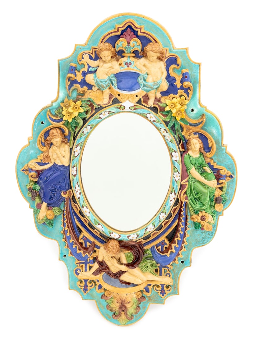 European Figural Majolica Framed Mirror: European Figural Scene Polychrome Glazed Majolica Framed Mirror, with nude figure above a Green Man masque. Mirror plate: 10.75" H x 7.75" W; frame: 28 H x 19.5" W x 3" D. Provenance: From an Upper Ea