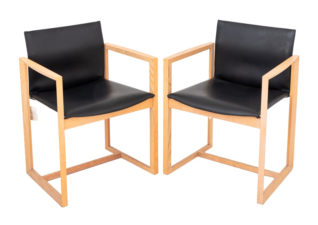 Piero Lissoni for Cassina "Eve" Armchairs, Pair: Pair of Piero Lissoni for Cassina "Eve" Arm Chairs, each with black leather seat and back, ash wood frame, and Cassina label. 29.75" H x 22.5" W x 18" D. Provenance: From a Vintage Collection of Itali