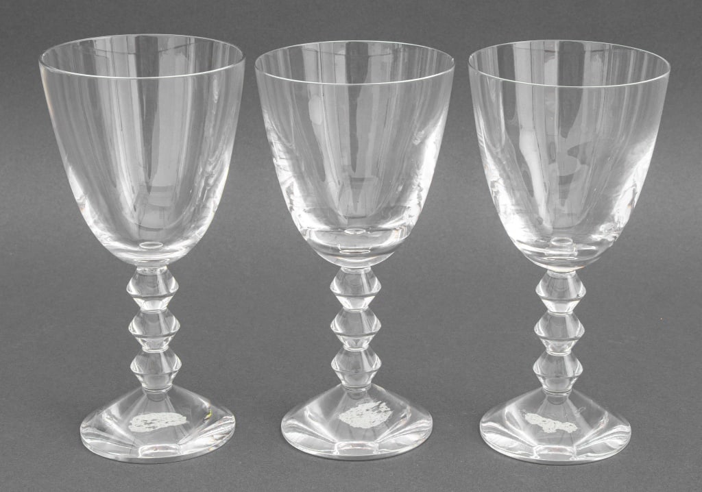 Baccarat "Vega Fortissimo" Tall Water Goblets, 3: Set of Three Baccarat Crystal "Vega Fortissimo" Tall Water Goblets, each marked and with Christie's label to underside. 7" H x 3.5" Diameter. Provenance: From a New York City Collection. Keywords: Cle