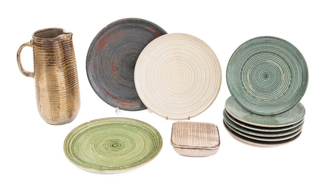 Design Technics Art Pottery Tableware, 11 Pcs.: Collection of 11 Design Technics Art Pottery Tableware Pieces, comprising: (1) one pitcher with ribbed texture and brown glaze, (6) six green glazed plates, (1) one square covered box, (2) plates one