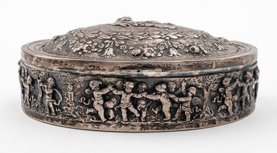 German Hanau Silver Cherub Motif Hinged Box: German Hanau Silver Lozenge Shaped Hinged Box, by Storck & Sinsheimer (1874-1926), decorated with repousse cherubs. Weight: 5.13 ozt.; 2" H x 4.625" W. Provenance: From a New York City Collection. Key