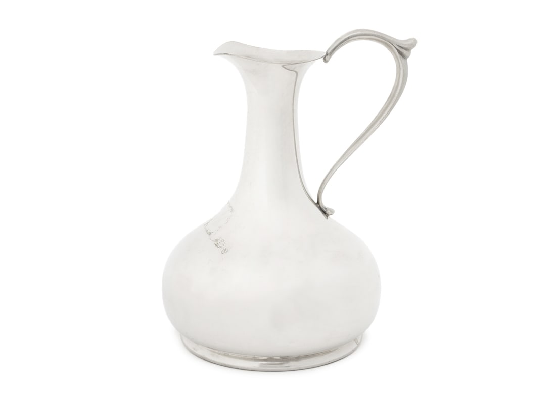 Cartier Pewter Modernist Style Pitcher: Cartier Polished Pewter Modernist Style Pitcher, marked on the underside. 8.75" H x 6" W. Provenance: From a New York City Collection. Keywords: Designer, Luxury brand, French design, Tableware, Ewer,