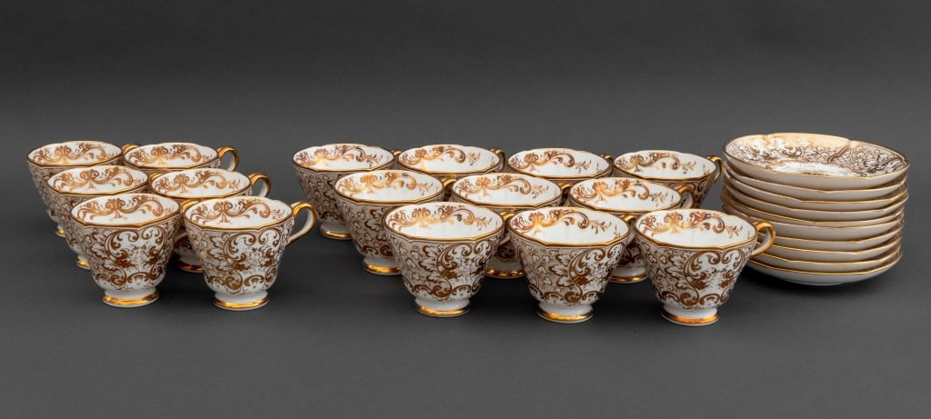 English Gilt Porcelain Tea Service, 26 Pcs.: English Gilt Porcelain Tea Service, comprising: ten (10) coffee cups, six (6) teacups, and ten (10) saucers, some with red ink "9325" marks to undersides. 26 pieces total. Coffee cup: 2.75" H x 4.5" W