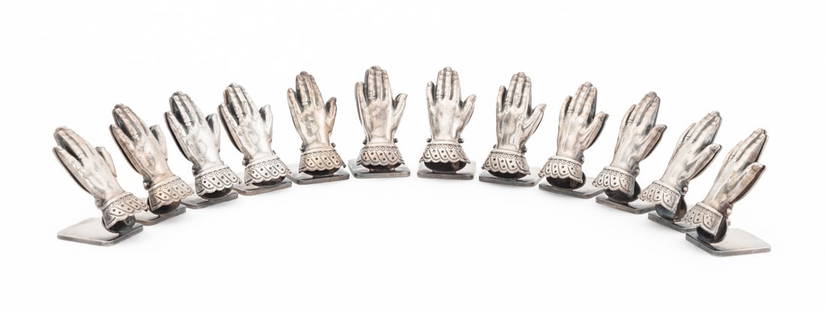 Spritzer & Fuhrmann Silver Plate Card Holders, 12: Set of Twelve Spritzer and Fuhrmann Silver Plate Hand Form Place Card Holders, each marked "Spritzer & Fuhrmann / S&F" to underside. 1.75" H x 0.75" W x 0.75" D. Provenance: From a Chelsea, New York C