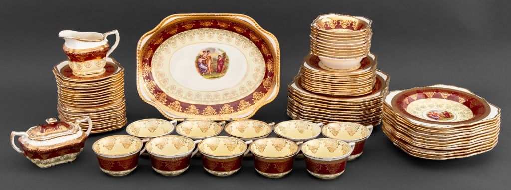 22K Gold Encrusted Porcelain Service, 81 Pcs.: 22K Yellow Gold Encrusted Porcelain Partial Service, each with figural vignette, marked "Warranted / 22 Carat Gold" to underside, and comprising: ten (10) tea cups, (1) a creamer jug, (1) covered two