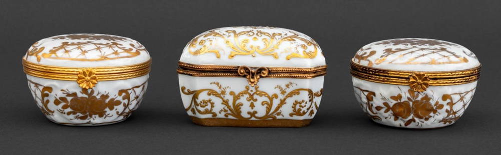 Limoges Gilt Porcelain Trinket Boxes, 3: Collection of Three Limoges Gilt Porcelain Trinket Boxes, with gilt floral motif, comprising: pair of Halga circular form with flower form closure, one with "Decore / Halga / Main / Paris" label to th