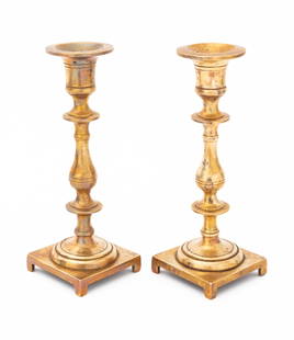 Victorian Gilt Bronze Candlesticks, Pair: Pair of Victorian Gilt Bronze Candlesticks, turned forms above square bases atop four feet. 7.5" H x 2.75" W x 2.75" D. Provenance: From a New York City Collection. Keywords: Lighting, Candleholders,