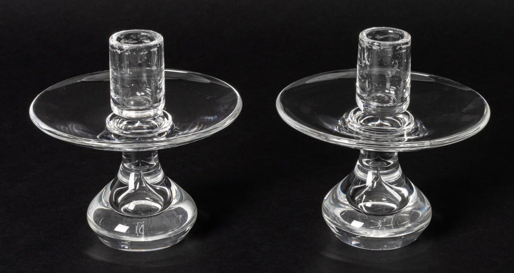 Steuben Crystal Candlesticks, Pair: Pair of Steuben Crystal Candlesticks, with drip plate, signed to underside. 5" H x 5.25" Diameter. Provenance: From a New York City Collection. Keywords: Glassware, Art Glass, Blown glass, Lighting, C