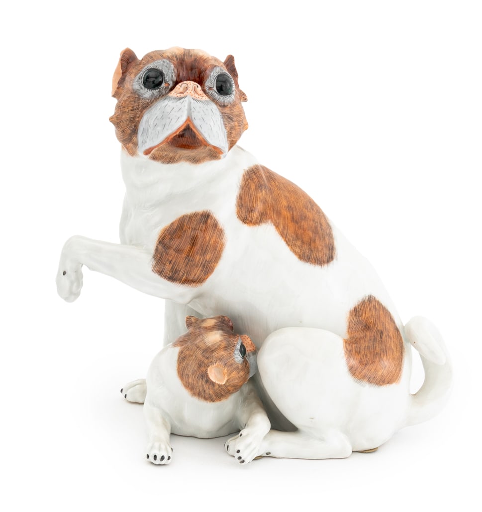 Dresden Porcelain Pug and Pup Sculpture: Dresden Porcelain Pug with Puppy Sculpture, depicting spotted pug mother nursing her pup, with SP Dresden mark and impressed "D6422" to underside. 9" H x 10" W x 7.5" D. Provenance: From a Chelsea, Ne