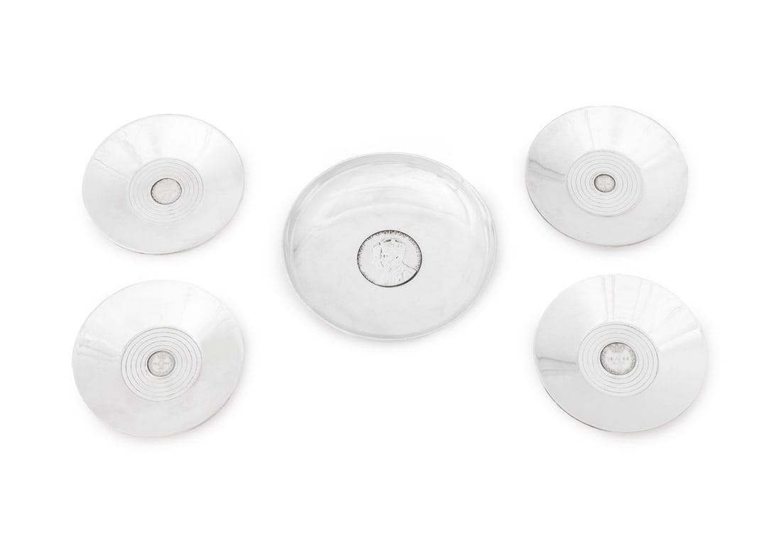 George V Sterling Silver Coin Inset Dishes, 5: Collection of Five George V Sterling Silver Coin Inset Dishes, comprising: set of four with pence coins to center, struck with marks for Mappin & Webb, Birmingham, 1935 to the underside and one with K