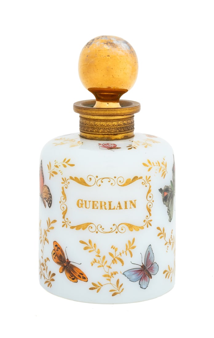 Guerlain Opaline Perfume Bottle: Guerlain Opaline Perfume Bottle, with round gilt stopper and brass mounted rim, painted butterfly and gilt floral motif, signed "R. Noirot" to the base. 6.5" H x 3.5" Diameter. Provenance: The Upper E