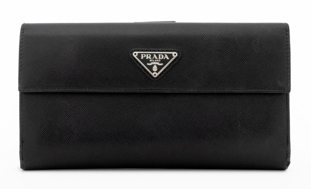 Prada Black Saffiano Leather Wallet: Prada Black Saffiano Leather Wallet, "Prada / Milano" silver-tone metal plaque to front closure and opposite side opening to four pockets and 13 credit card slots, impressed mark "Prada / Milano / Mad