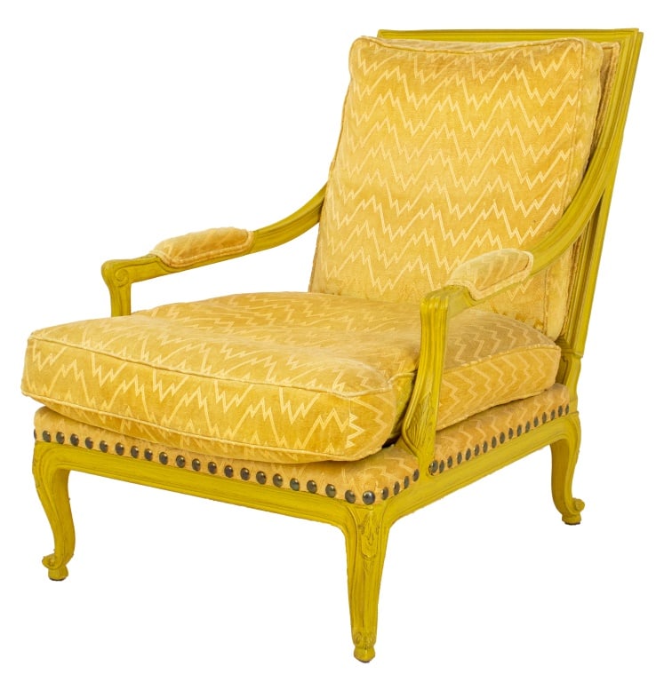 Louis XV Style Yellow Painted Bergere: Louis XV Style Yellow Painted Bergere, raised on cabriole legs with carved floral motif, the seat, back, and armrests upholstered in yellow fabric. 35.5" H x 27" W x 39" D; seat: 17" H. Provenance: Pr