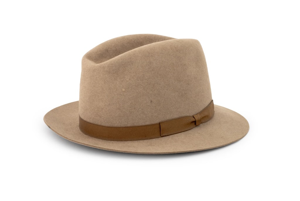 Hermes Brown Beaver Fedora: Hermes Brown Beaver Fedora, with tan cotton bow and trim lining to the interior, with "Hermes" label to the underside. 5" H x 10.5" W x 12" D. Size 56. Provenance: From a Greenwich, Connecticut Collec