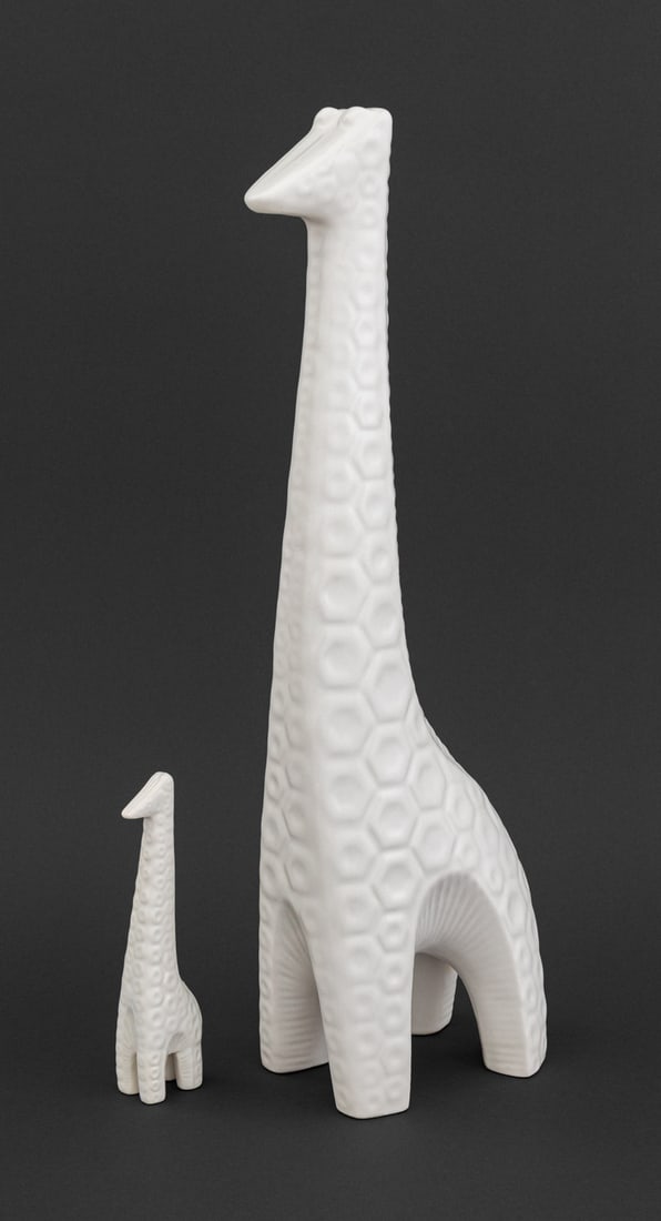 Jonathan Adler Giraffe White Ceramic Sculptures, 2: Two Jonathan Adler Standing Giraffe White Glazed Ceramic Sculptures, the larger marked to underside. Larger: 18 H x 8" W x 4" D. Provenance: From a New York City Area Collection. Keywords: Designer de
