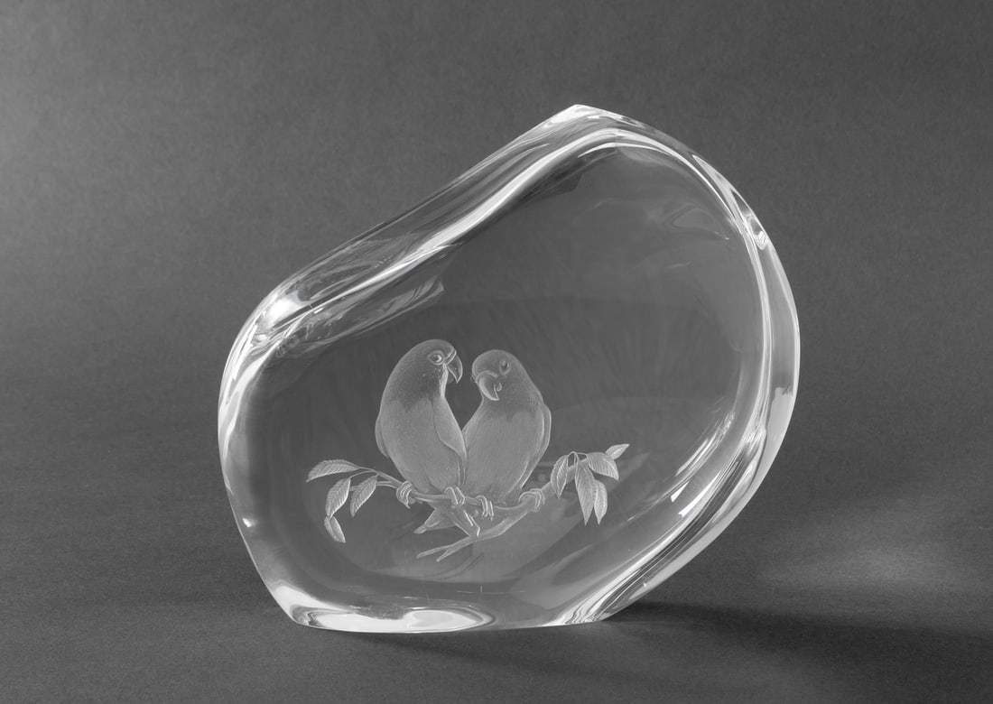 Steuben "Lovebirds" Glass Sculpture, 2003: Steuben "Lovebirds" Glass Sculpture, 2003, designed by Taf Lebel Schaefer, shape 0557, marked "Steuben" and numbered edition "45/50" to underside. 7" H x 7.5" W x 2.25" D. Provenance: From a Long Isla