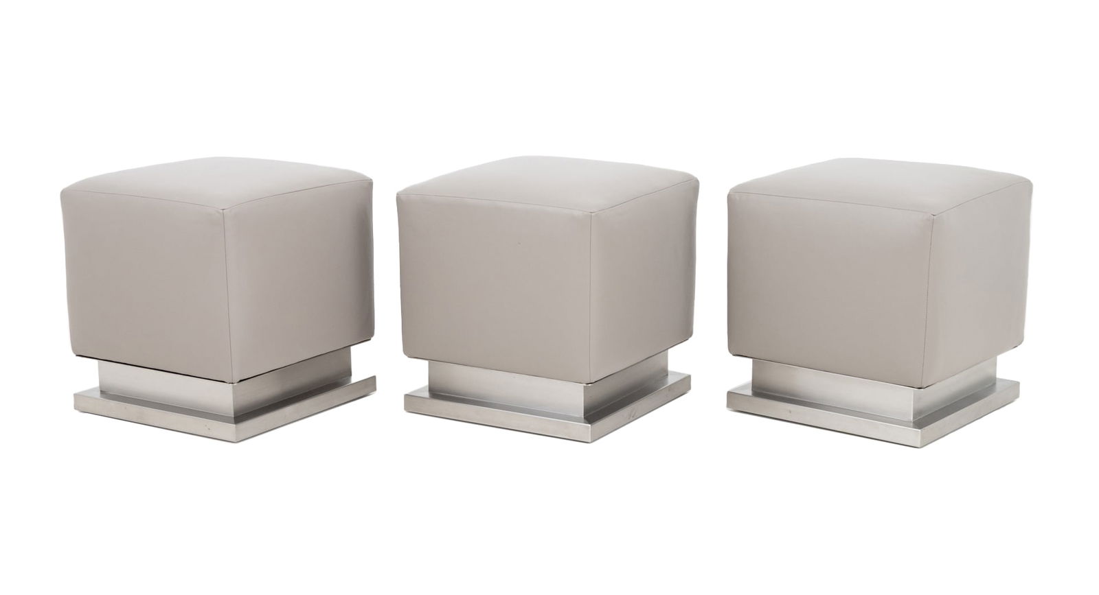 Leather Upholstered Steel Rolling Ottomans, 3: Set of Three Grey Leather Upholstered Brushed Stainless Steel Rolling Ottomans, on wheels. 19" H x 18" W x 18" D. Provenance: From a Long Island Estate. Keywords: Modern Furniture, Seating, Stools, Mo