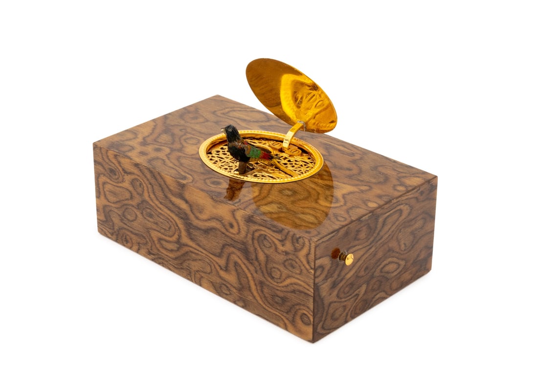 Reuge Music No. 198 Ash Singing Bird Box: Reuge Music No. 198 Ash Wood Singing Bird Box, the gilt metal oval top opening to pierced interior with automaton bird, marked "Reuge Music / Sainte-Croix / Made in Switzerland / No 0198" to the under