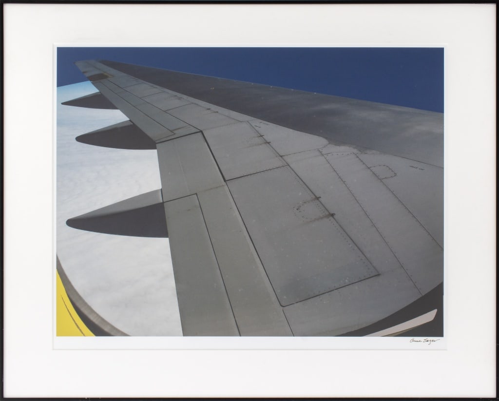 Anne Sager Airplane Wing Chromogenic Print: Anne Sager (American, 1930-2024), Airplane Wing, Chromogenic Print in Colors, signed in pen lower right, black frame. Image: 15" H x 20" W; frame: 20.75" H x 25.75" W x 1" D. Provenance: From a 35 Eas