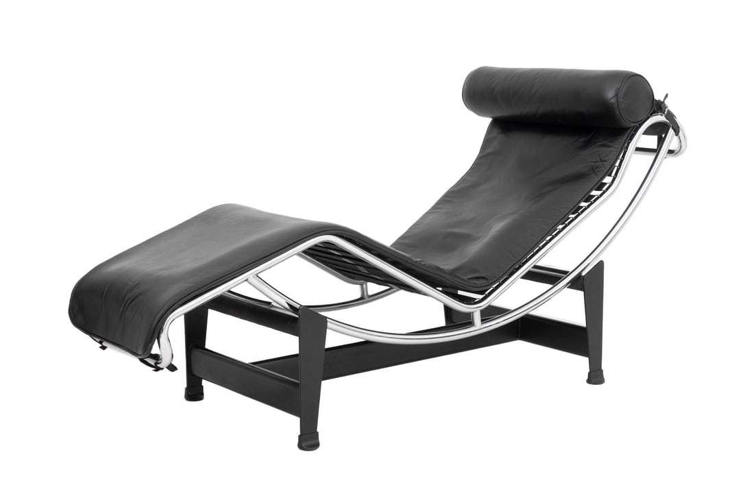 Le Corbusier "LC4" Black Leather Chaise Longue: Charlotte Perriand, Pierre Jeanneret, and Le Corbusier "LC4" Black Leather Chaise Longue, with chrome-plated steel frame, the base marked "Cassina / LC". 34" H x 59" W x 23" D. Provenance: From a New